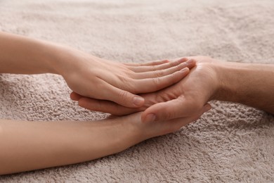 Photo of Man receiving hand massage on soft towel, closeup