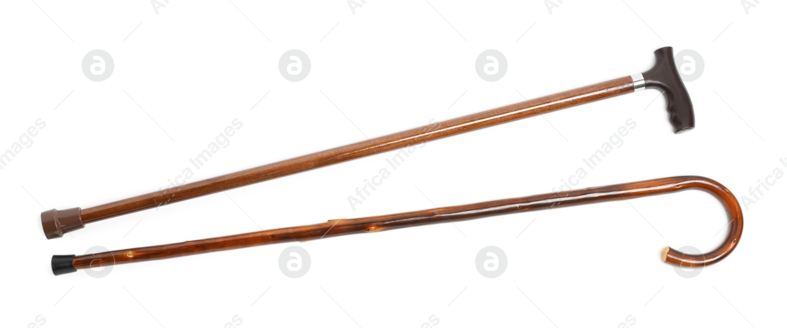 Photo of Different wooden walking canes isolated on white