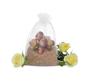 Photo of Scented sachet with dried roses and fresh flowers on white background