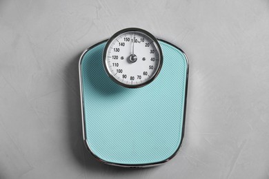 Photo of One bathroom scale on grey textured background, top view