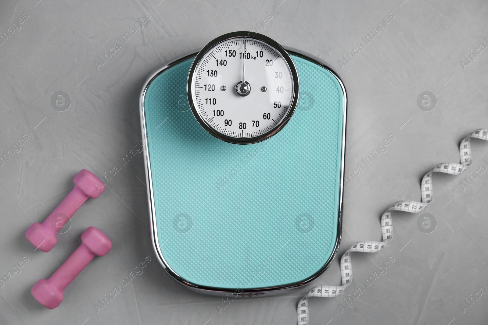 Photo of Bathroom scale, measuring tape and dumbbells on grey textured background, flat lay