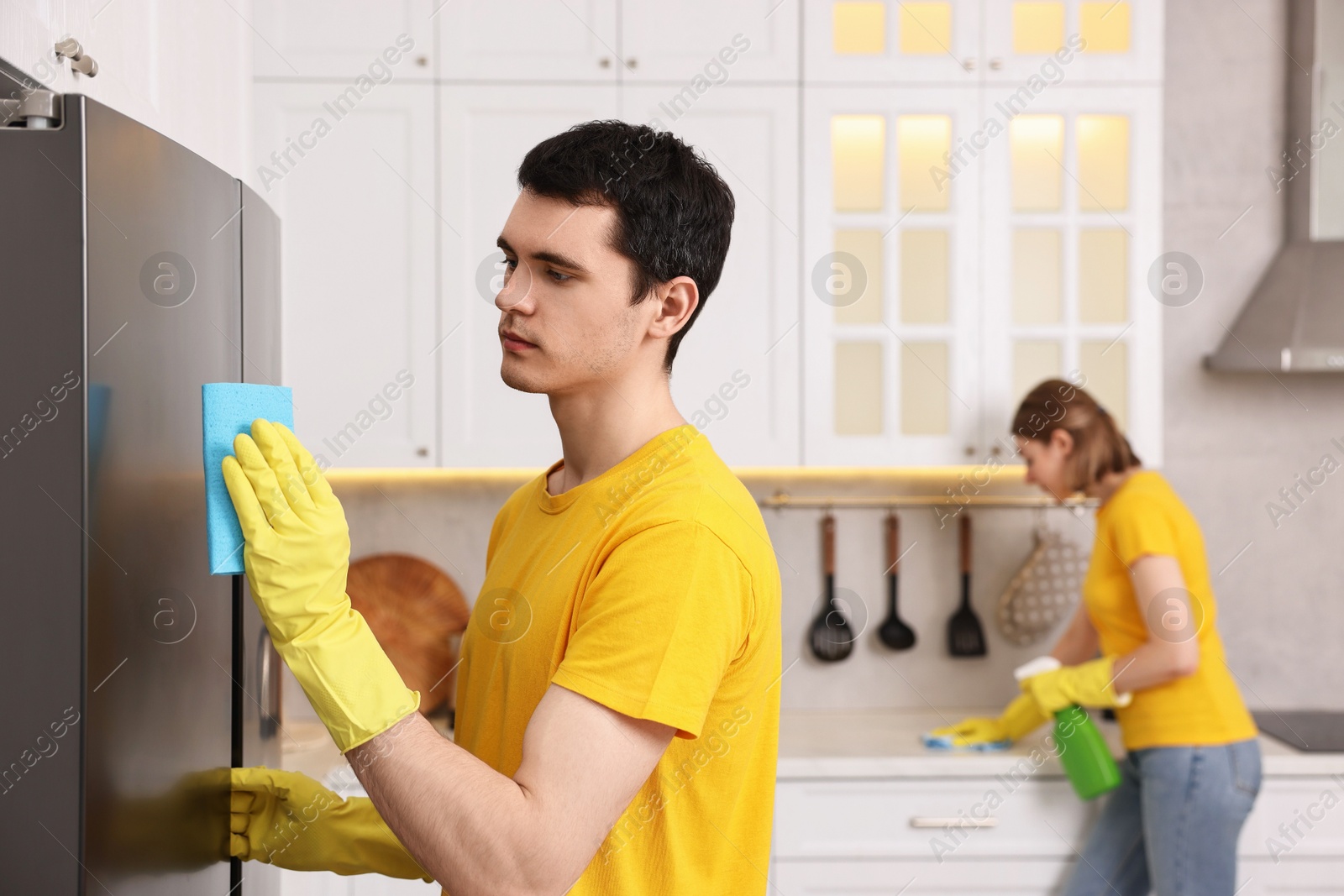 Photo of Professional janitors working in kitchen. Cleaning service