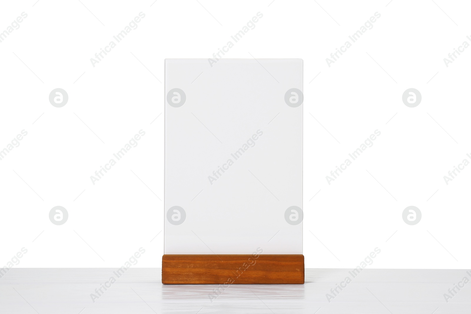 Photo of Menu holder on light wooden table against white background. Mockup for design