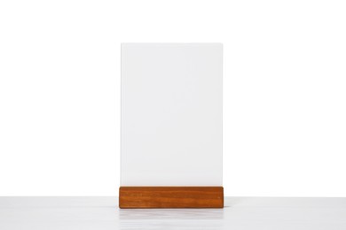 Photo of Menu holder on light wooden table against white background. Mockup for design