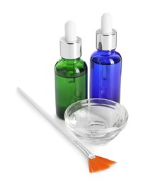 Photo of Bottles of chemical peel, bowl with liquid and brush isolated on white. Peeling procedure