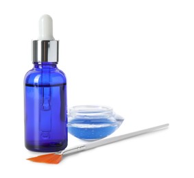 Photo of Bottle of chemical peel, bowl with liquid and brush isolated on white. Peeling procedure