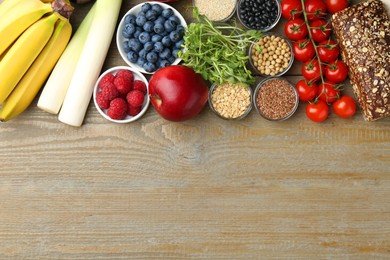 Photo of Source of prebiotics. Different fresh products on wooden table, flat lay. Space for text