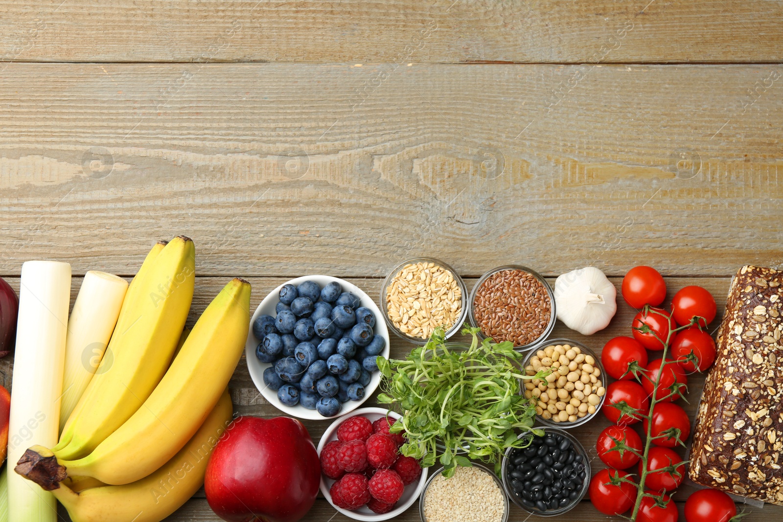 Photo of Source of prebiotics. Different fresh products on wooden table, flat lay. Space for text