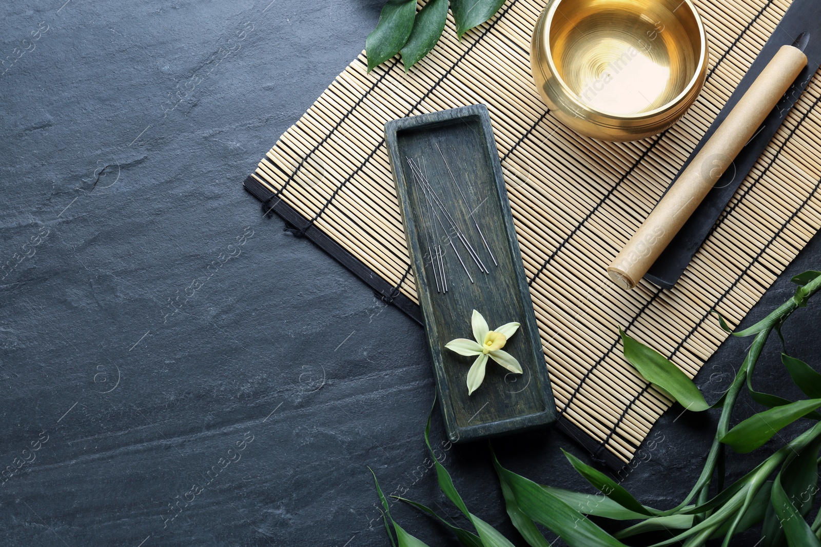 Photo of Flat lay composition with acupuncture needles on black table. Space for text