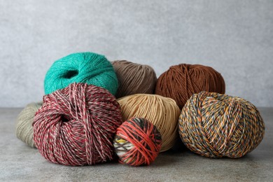 Photo of Many different soft woolen yarns on grey table