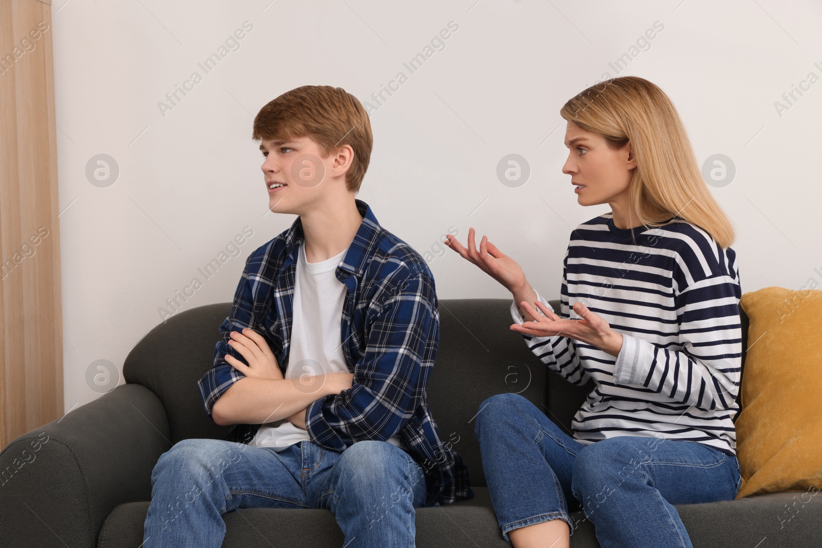 Photo of Mother and her teenage son having argument at home