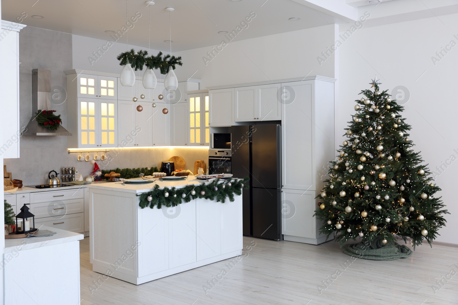 Photo of Cozy spacious kitchen decorated for Christmas. Interior design