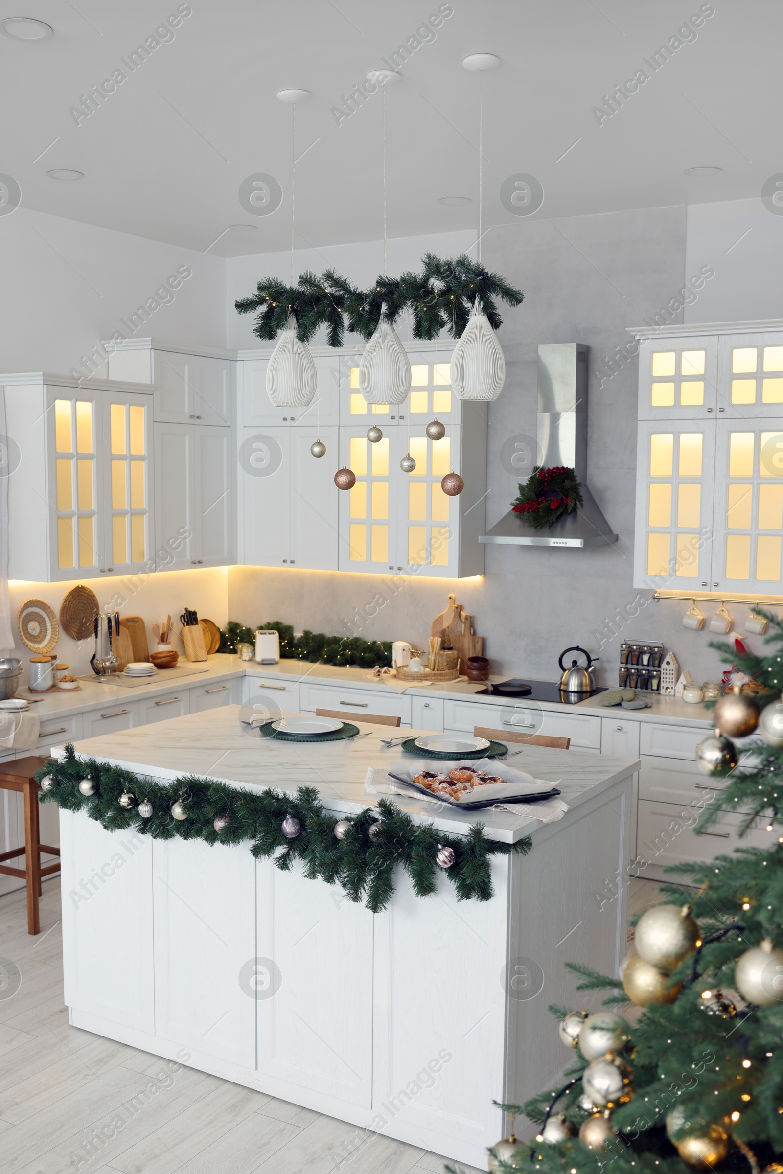 Photo of Cozy spacious kitchen decorated for Christmas. Interior design