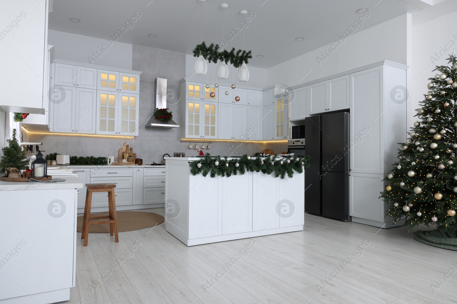 Photo of Cozy spacious kitchen decorated for Christmas. Interior design