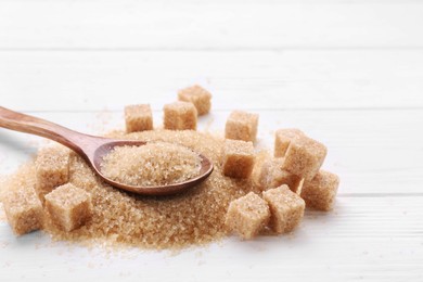 Different types of brown sugar on white wooden table