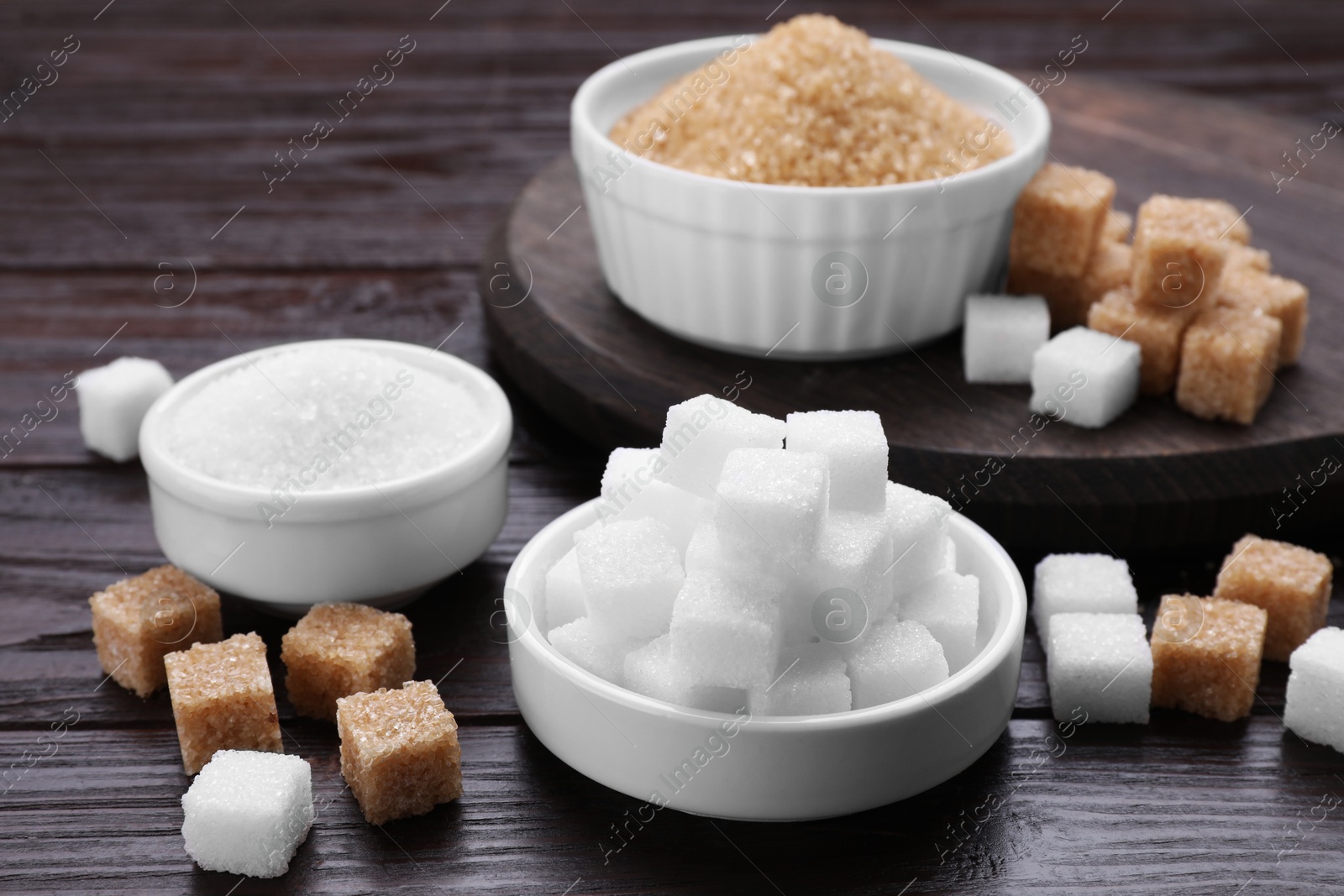 Photo of Different types of sugar on wooden table