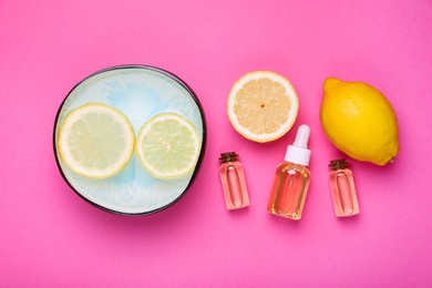 Flat lay composition with bowl of water and lemons on pink background. Spa treatment