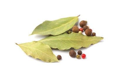 Aromatic bay leaves and peppercorns on white background