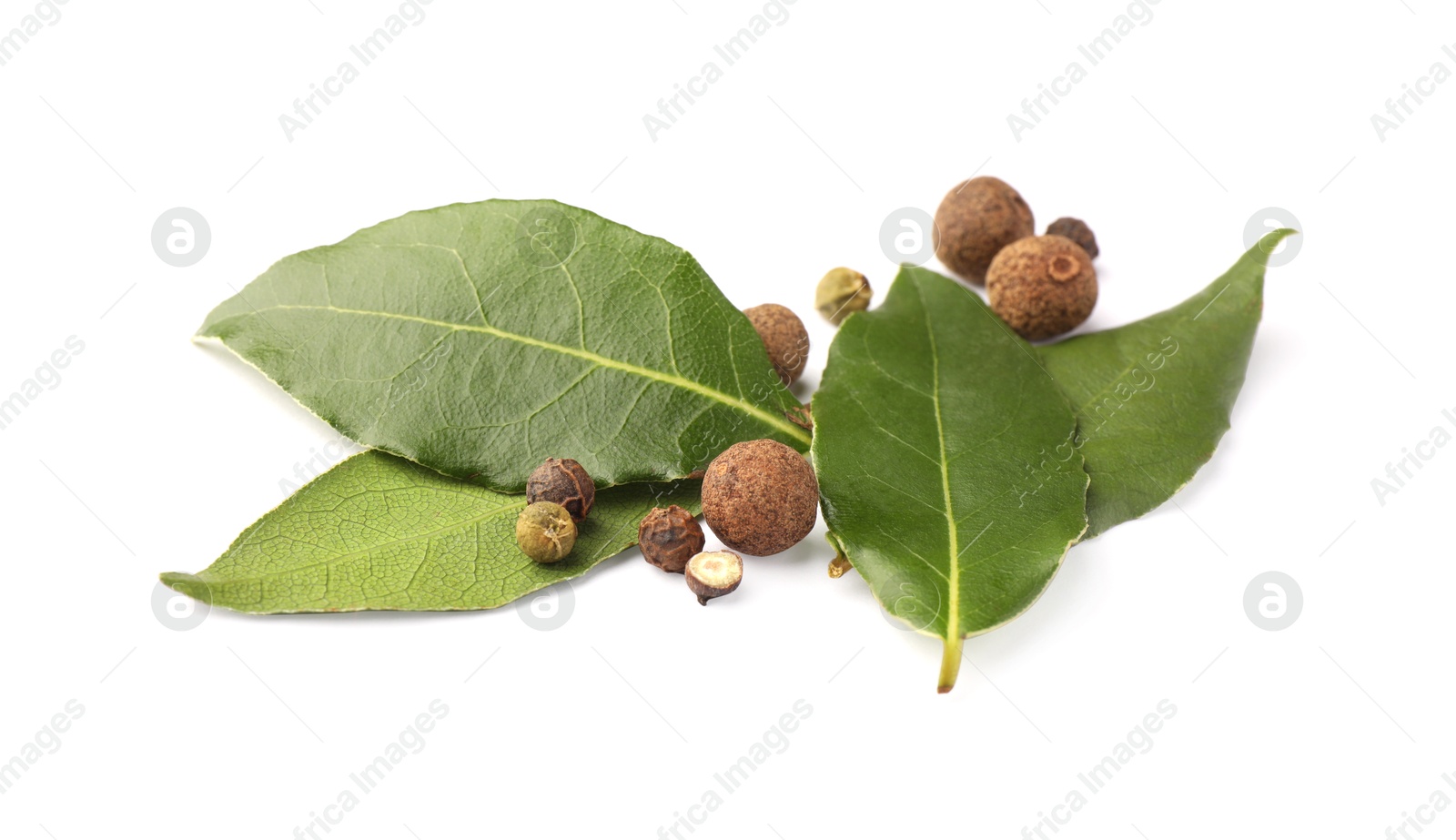 Photo of Fresh green bay leaves and peppercorns on white background