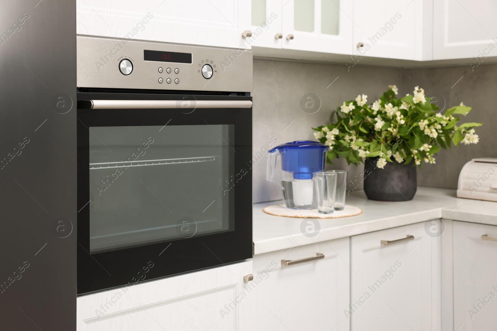 Photo of New electric oven in kitchen. Cooking appliance