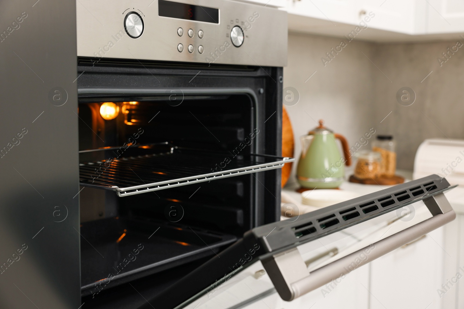 Photo of Open electric oven in kitchen. Cooking appliance