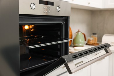 Photo of Open electric oven in kitchen. Cooking appliance