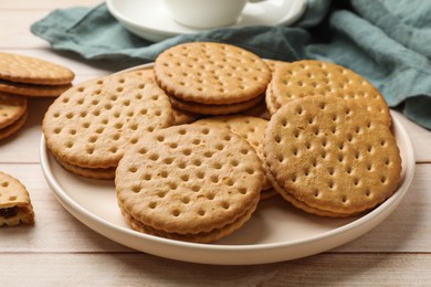 Photo of Fresh tasty sandwich cookies on wooden table, closeup