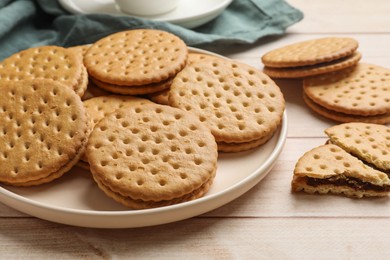 Photo of Fresh tasty sandwich cookies on wooden table, closeup