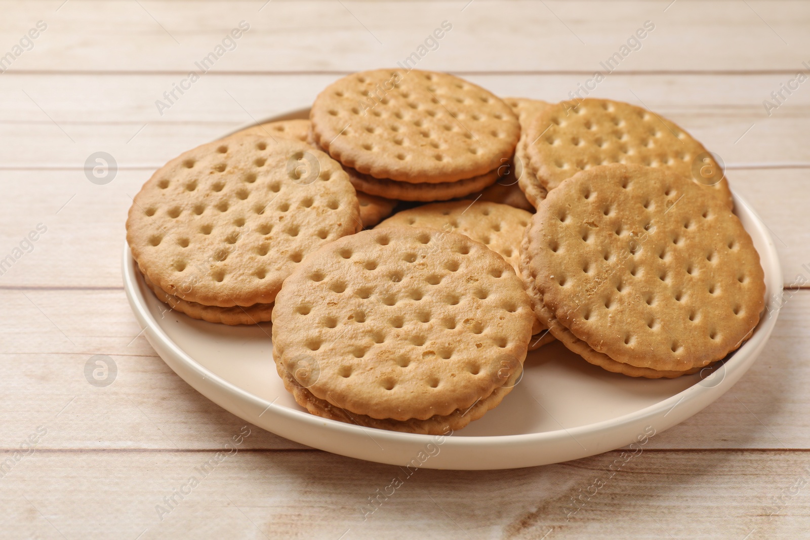 Photo of Fresh tasty sandwich cookies on wooden table