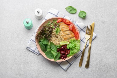 Photo of Healthy meal. Tasty vegetables, quinoa and chicken breast in bowl on white table, flat lay