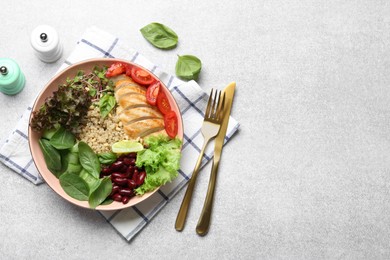 Photo of Healthy meal. Tasty vegetables, quinoa and chicken breast in bowl on white table, flat lay. Space for text