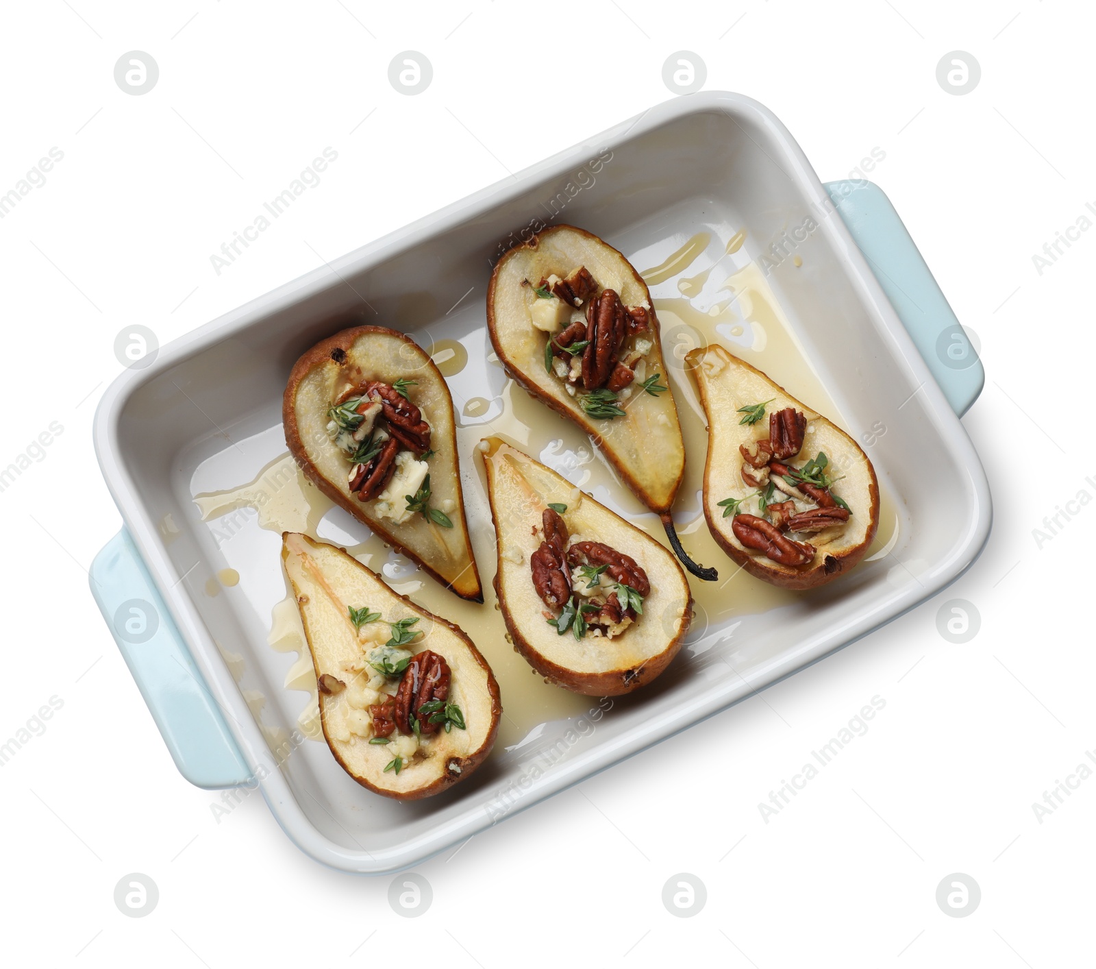 Photo of Tasty baked pears with nuts, blue cheese, thyme and honey in baking dish on white background, top view