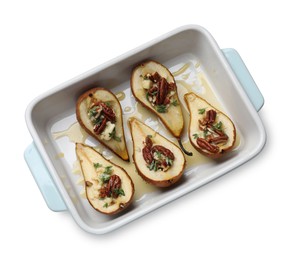 Photo of Tasty baked pears with nuts, blue cheese, thyme and honey in baking dish on white background, top view