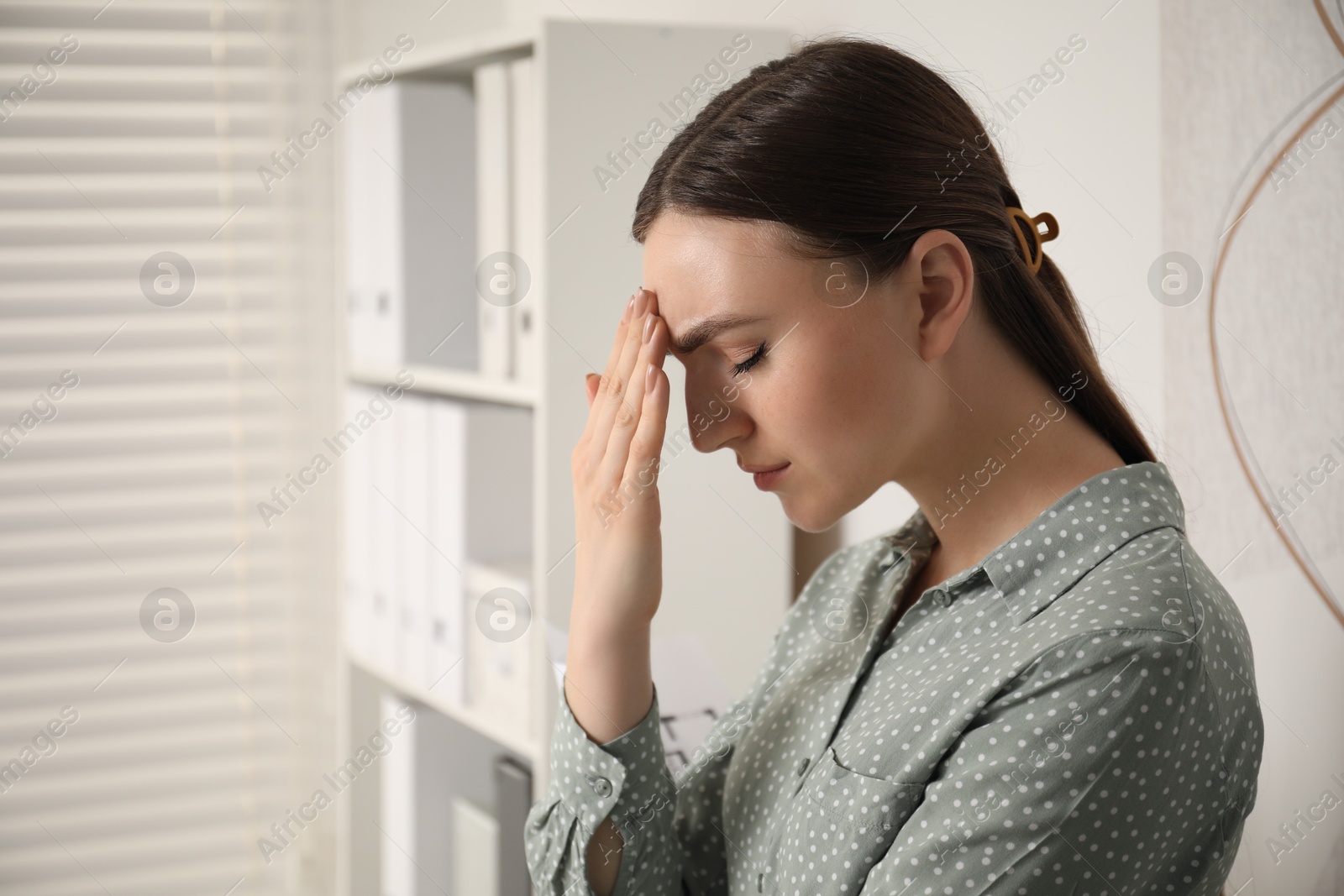 Photo of Embarrassed woman in office, space for text