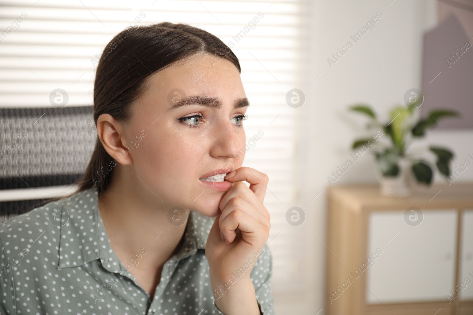 Photo of Embarrassed woman in office, space for text