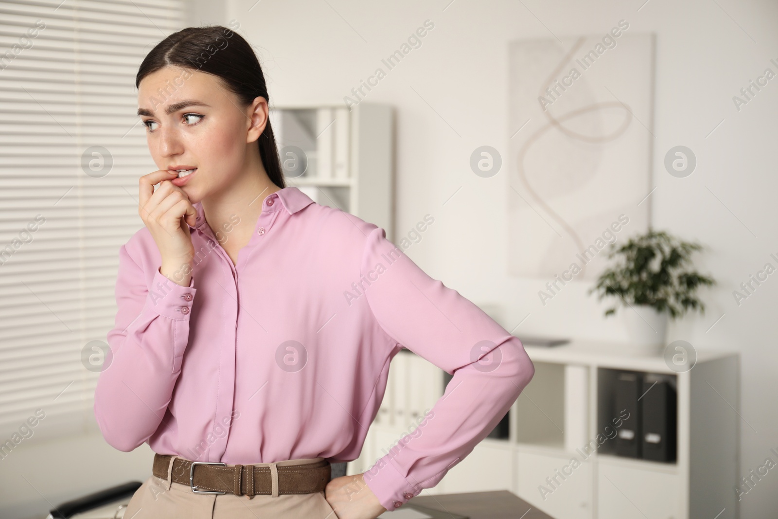 Photo of Embarrassed woman in office, space for text