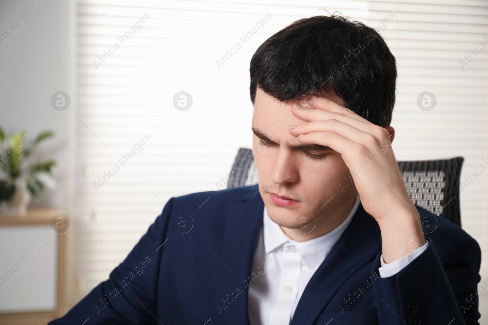 Photo of Portrait of embarrassed young man in office