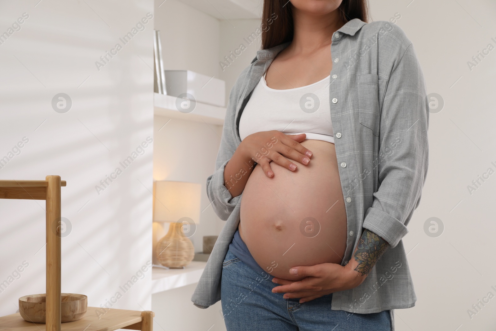 Photo of Pregnant woman in living room, closeup view