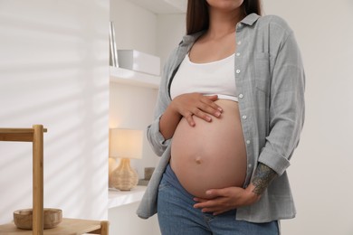 Pregnant woman in living room, closeup view