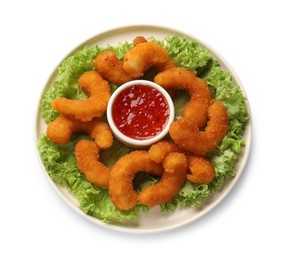 Delicious breaded fried shrimps, sauce and lettuce isolated on white, top view