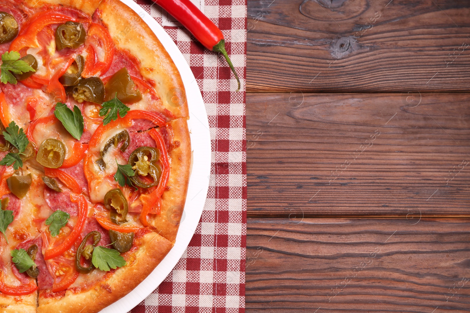 Photo of Delicious hot pizza Diablo on wooden table, top view. Space for text