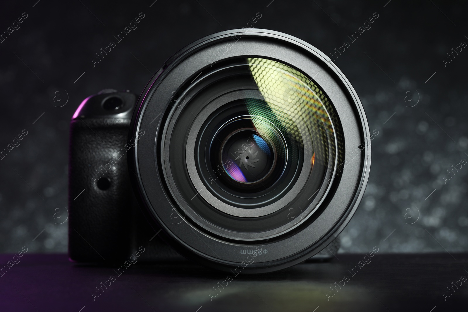 Photo of Modern photo camera on black table. Photographer's equipment