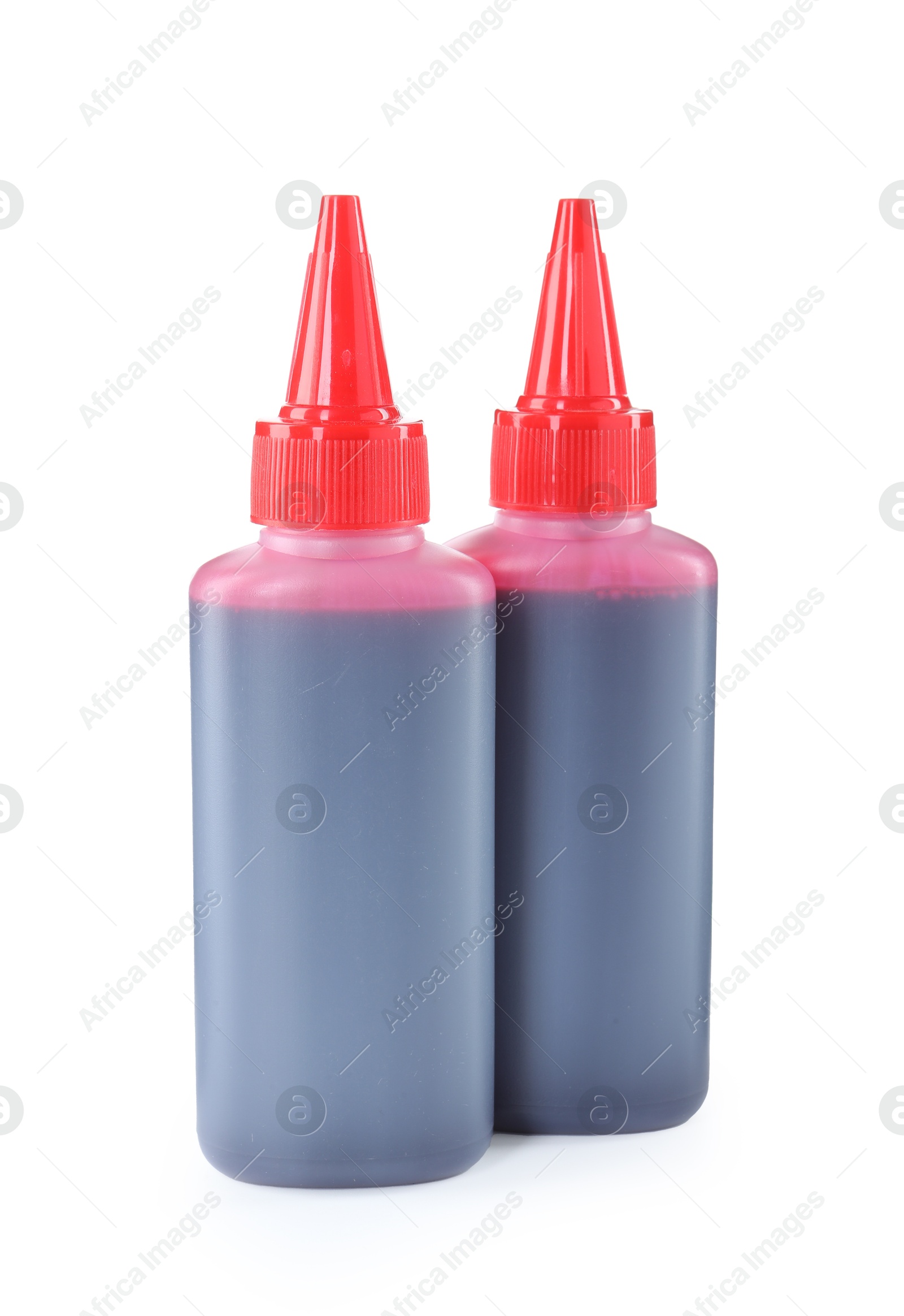 Photo of Bottle of red printer ink isolated on white