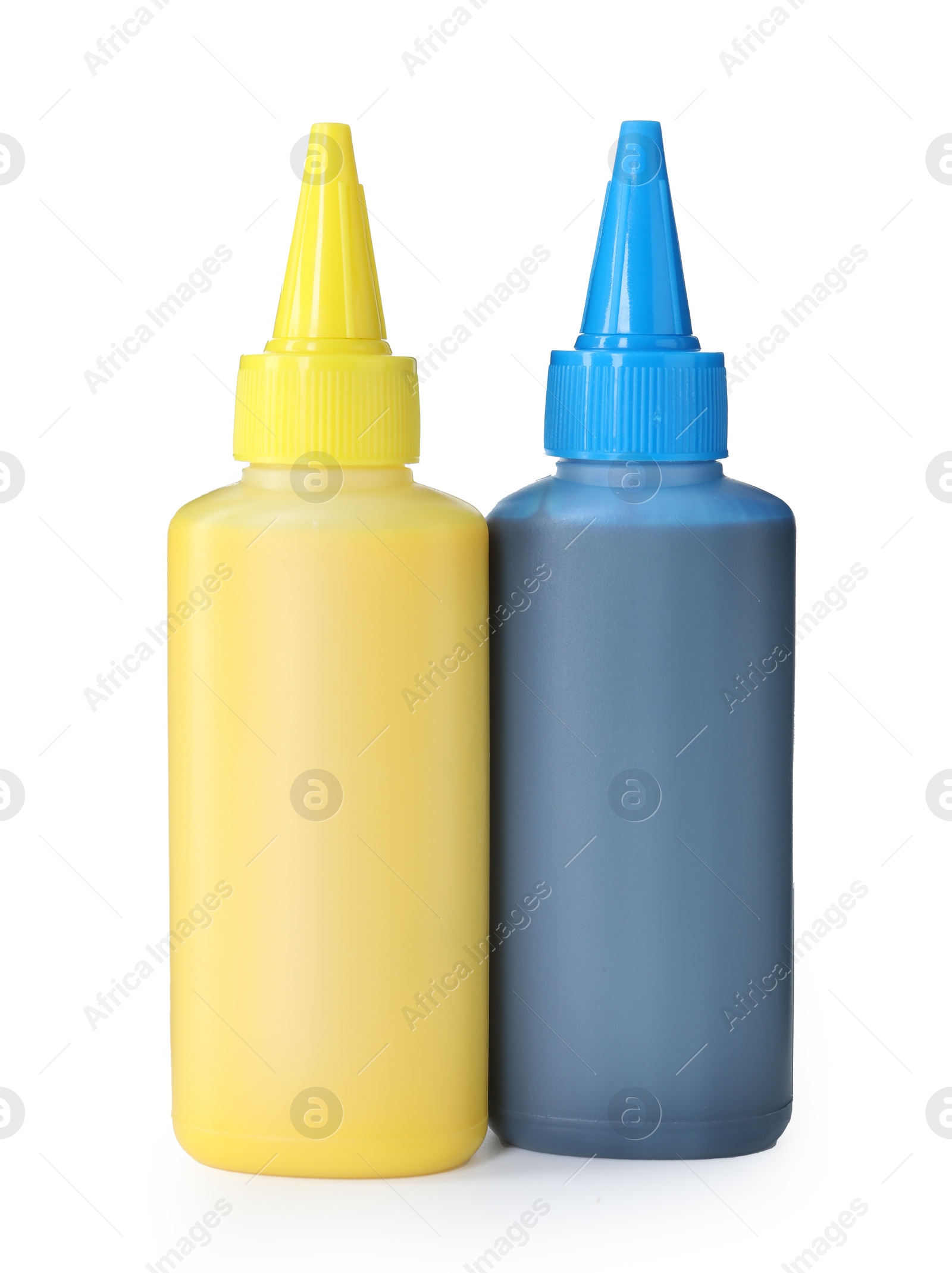 Photo of Bottles of different printer ink isolated on white