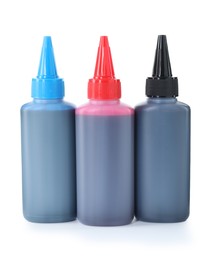 Photo of Bottles of different printer ink isolated on white