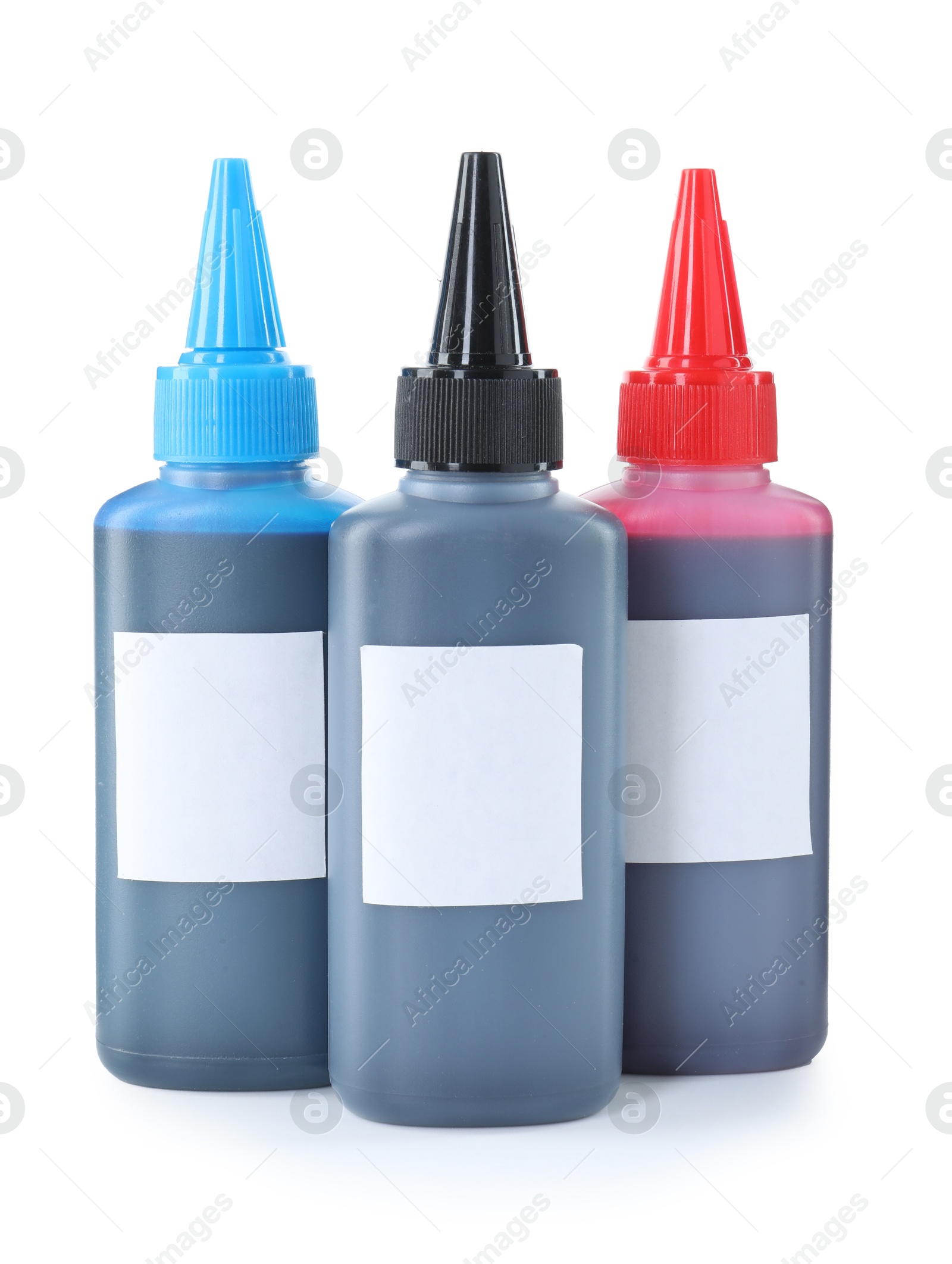 Photo of Bottles of different printer ink isolated on white