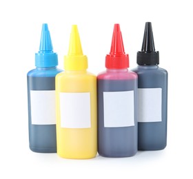 Photo of Bottles of different printer ink isolated on white