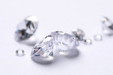 Photo of Many beautiful shiny diamonds on white background, closeup