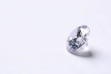 One beautiful shiny diamond on white background, closeup. Space for text