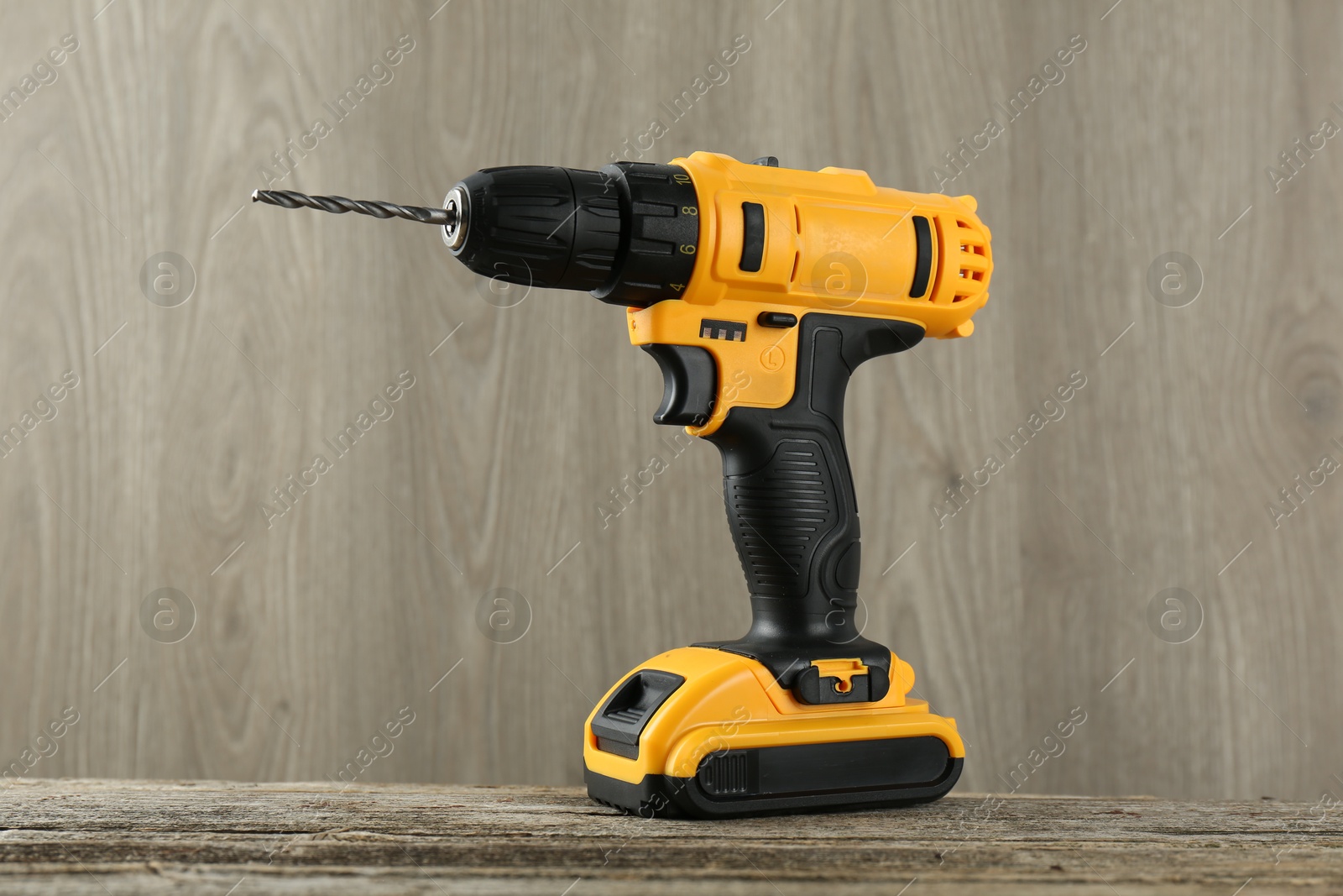 Photo of One cordless electric drill on wooden table